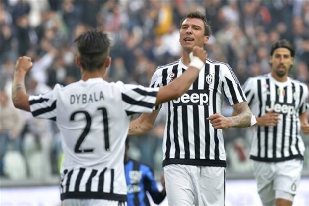 Juventus' Mario Mandzukic, right, celebrates with his teammate Paulo Dybala after scoring during a Serie A soccer match between Juventus and Atalanta at the Juventus stadium, in Turin, Italy, Sunday, Oct. 25, 2015. (AP Photo/Massimo Pinca)