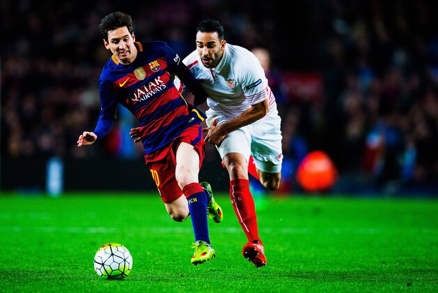 BARCELONA, SPAIN - FEBRUARY 28: Lionel Messi of Barcelona and Adil Rami of Sevilla battle for the ball during the La Liga match between FC Barcelona and Sevilla FC at Camp Nou on February 28, 2016 in Barcelona, Spain.  (Photo by Vladimir Rys Photography via Getty Images)