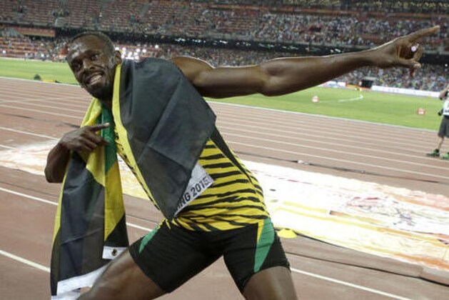 FILE - In this Aug. 23, 2015, file photo, Jamaica's Usain Bolt celebrates after winning the gold medal in the men's 100-meter ahead of United States' at the World Athletics Championships at the Bird's Nest stadium in Beijing. Even though David Rudisha, the 800-meter Olympic champion from Kenya, refers to Bolt as his brother from another mother, you really couldn’t get two more contrasting characters. (AP Photo/Lee Jin-man, File)