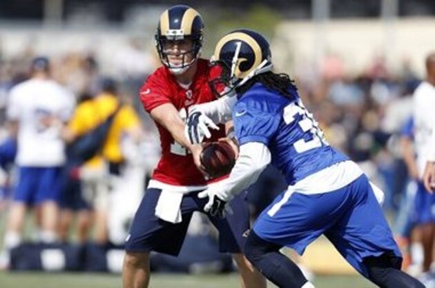 Los Angeles Rams quarterback Case Keenum, left, hands off the ball to running back Todd Gurley, right, during the NFL football team's training camp, Saturday, July 30, 2016, in Irvine, Calif. (AP Photo/Ryan Kang)