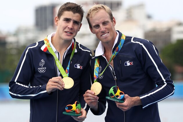 RIO DE JANEIRO, BRAZIL - AUGUST 12: Gold medalists  Pierre Houin (L) and Jeremie Azou (R) of France celebrate on the podium at the medal ceremony for the Lightweight Men's Double Sculls on Day 7 of the Rio 2016 Olympic Games at Lagoa Stadium on August 12, 2016 in Rio de Janeiro, Brazil.  (Photo by Phil Walter/Getty Images)