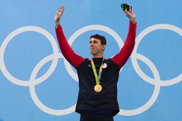 Aug 11, 2016; Rio de Janeiro, Brazil; Michael Phelps (USA) with his gold medal after the men's 200m individual medley final in the Rio 2016 Summer Olympic Games at Olympic Aquatics Stadium. Mandatory Credit: Rob Schumacher-USA TODAY Sports