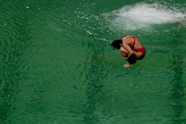 A diver takes part in a training session after the water in the diving pool turned green in the Maria Lenk Aquatic Center at the 2016 Summer Olympics in Rio de Janeiro, Brazil, Wednesday, Aug. 10, 2016. (AP Photo/Matt Dunham)