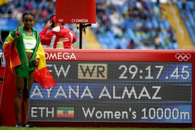 Ethiopia's Almaz Ayana poses by the results board after she broke the World Record in the Women's 10,000m during the athletics event at the Rio 2016 Olympic Games at the Olympic Stadium in Rio de Janeiro on August 12, 2016.   / AFP / OLIVIER MORIN        (Photo credit should read OLIVIER MORIN/AFP/Getty Images)
