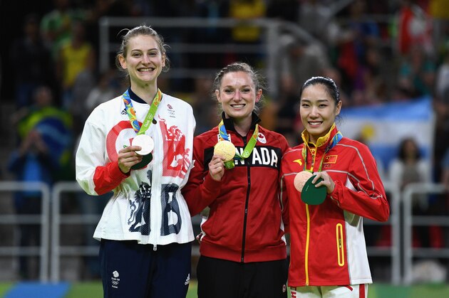 RIO DE JANEIRO, BRAZIL - AUGUST 12:  (L-R) Silver medalist Bryony Page of Great Britain, gold medalist Rosannagh Maclennan of Canada and bronze medalist Dan Li of China pose during the medal ceremony for the Trampoline Gymnastics Women's Final on Day 7 of the Rio 2016 Olympic Games at the Rio Olympic Arena on August 12, 2016 in Rio de Janeiro, Brazil.  (Photo by David Ramos/Getty Images)