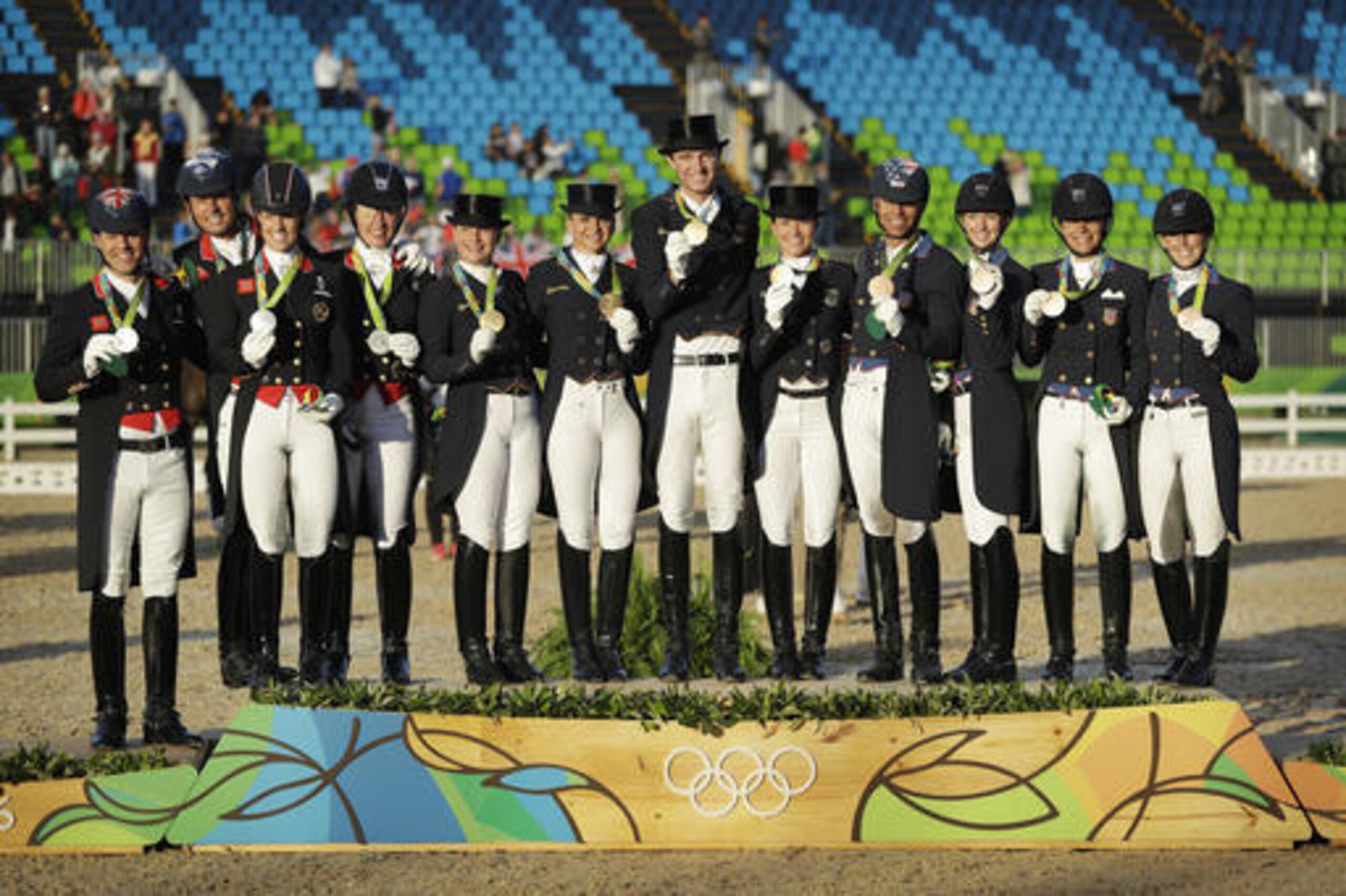 Germany, gold medal winners, Britain, silver medal winners and United States, bronze medal winners, stand on the podium after the equestrian dressage team competition at the 2016 Summer Olympics in Rio de Janeiro, Brazil, Friday, Aug. 12, 2016. (AP Photo/John Locher)
