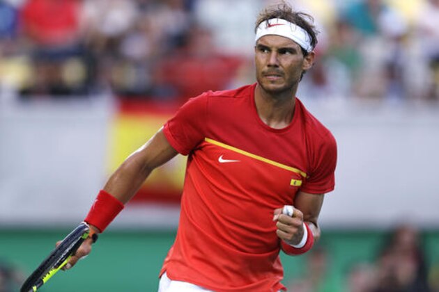 Rafael Nadal, of Spain, pumps his fist after winning a point against Thomaz Bellucci, of Brazil, during their quarter final round match at the 2016 Summer Olympics in Rio de Janeiro, Brazil, Friday, Aug. 12, 2016. Nadal defeated Bellucci in three sets. (AP Photo/Charles Krupa)