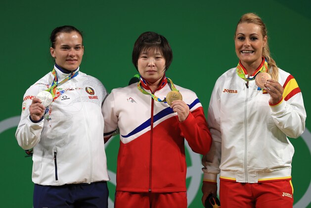 RIO DE JANEIRO, BRAZIL - AUGUST 12:  (L-R) Silver medalist Darya Naumava of Belarus, Gold medalist Jong Sim Rim of North Korea and bronze medalist Lidia Valentin Perez of Spain pose on the podium during the medal ceremony for the Weightlifting - Women's 75kg on Day 7 of the Rio 2016 Olympic Games at Riocentro - Pavilion 2 on August 12, 2016 in Rio de Janeiro, Brazil.  (Photo by Mike Ehrmann/Getty Images)