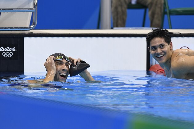 Singapore's Joseph Schooling smiles next to USA's Michael Phelps (L) after the Men's 100m Butterfly Final during the swimming event at the Rio 2016 Olympic Games at the Olympic Aquatics Stadium in Rio de Janeiro on August 12, 2016.  / AFP / CHRISTOPHE SIMON        (Photo credit should read CHRISTOPHE SIMON/AFP/Getty Images)