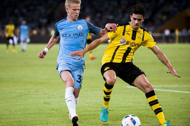 SHENZHEN - JULY 28: Manchester City striker Alex Zinchenko (l) fights for the ball with Borussia Dortmund defender Marc Bartra (r) during the 2016 International Champions Cup China match at the Shenzhen Stadium on 28 July 2016 in Shenzhen, China. (Photo by Power Sport Images/Getty Images)