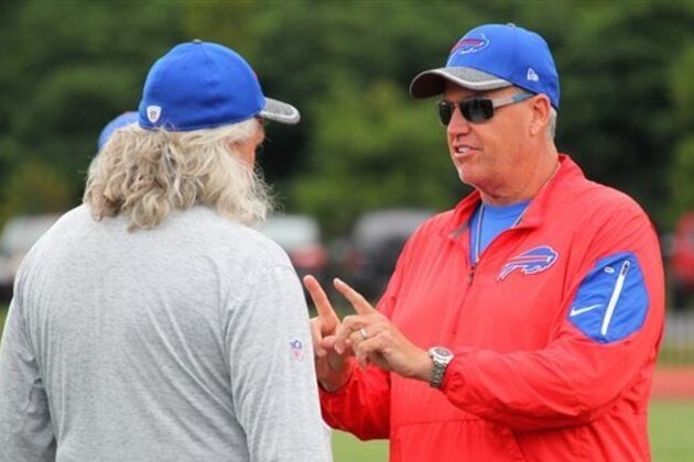Buffalo Bills assistant head coach-defense Rob Ryan, left, and his brother, head coach Rex Ryan, right, talk during NFL football training camp in Pittsford, N.Y., Monday, Aug. 1, 2016. (AP Photo/Bill Wippert)