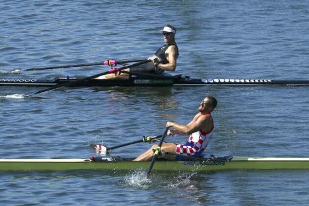 Mahe Drysdale, of New Zealand, top, and Damir Martin, of Croatia, compete in the single sculls rowing final at Lagoa during the Summer Olympics in Rio De Janeiro, Brazil, Saturday, Aug. 13, 2016. Drysdale took the gold, and Martin the silver.  (Jeremy Lee/Pool Photo via AP)