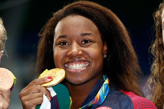 RIO DE JANEIRO, BRAZIL - AUGUST 11: Gold medalist Simone Manuel of the United States celebrates during the medal ceremony for the Women's 100m Freestyle Final on Day 6 of the Rio 2016 Olympic Games at the Olympic Aquatics Stadium on August 11, 2016 in Rio de Janeiro, Brazil. (Photo by Clive Rose/Getty Images) RIO DE JANEIRO, BRAZIL - AUGUST 11: Gold medalist Simone Manuel of the United States celebrates during the medal ceremony for the Women's 100m Freestyle Final on Day 6 of the Rio 2016 Olympic Games at the Olympic Aquatics Stadium on August 11, 2016 in Rio de Janeiro, Brazil. (Photo by Clive Rose/Getty Images)