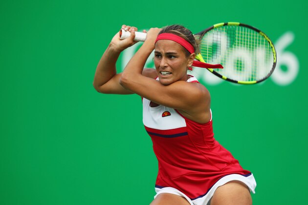 RIO DE JANEIRO, BRAZIL - AUGUST 12:  Monica Puig of Puerto Rico returns a backhand against Petra Kvitova of the Czech Republic during the Women's Singles Semifinal on Day 7 of the Rio 2016 Olympic Games at the Olympic Tennis Centre on August 12, 2016 in Rio de Janeiro, Brazil.  (Photo by Clive Brunskill/Getty Images)