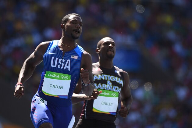 US Justin Gatlin (L) and Antigua's Daniel Bailey compete in the Men's 100m Round 1 during the athletics event at the Rio 2016 Olympic Games at the Olympic Stadium in Rio de Janeiro on August 13, 2016.   / AFP / OLIVIER MORIN        (Photo credit should read OLIVIER MORIN/AFP/Getty Images)