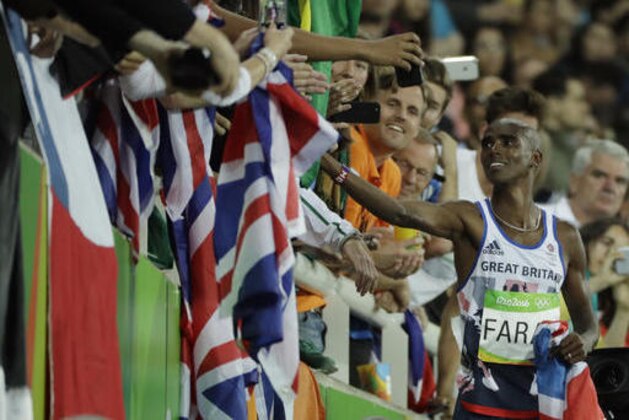Britain's Mo Farah greets spectators after winning the gold medal in the men's 10,000-meter final during the athletics competitions of the 2016 Summer Olympics at the Olympic stadium in Rio de Janeiro, Brazil, Saturday, Aug. 13, 2016. (AP Photo/Jae C. Hong)
