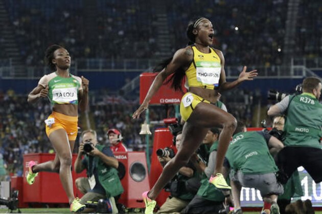 Jamaica's Elaine Thompson, right, wins the women's 100-meter final during the athletics competitions of the 2016 Summer Olympics at the Olympic stadium in Rio de Janeiro, Brazil, Saturday, Aug. 13, 2016. (AP Photo/David J. Phillip)