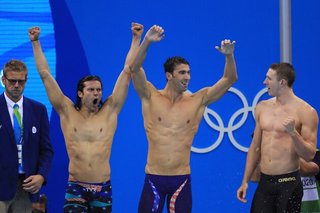 RIO DE JANEIRO, BRAZIL - AUGUST 13:  Ryan Murphy, Michael Phelps and Cody Miller of the United States celebrate winning gold in the Men's 4 x 100m Medley Relay Final on Day 8 of the Rio 2016 Olympic Games at the Olympic Aquatics Stadium on August 13, 2016 in Rio de Janeiro, Brazil.  (Photo by Tom Pennington/Getty Images)