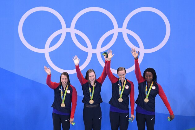 RIO DE JANEIRO, BRAZIL - AUGUST 13:  Kathleen Baker, Lilly King, Dana Vollmer, Simone Manuel of the United States celebrate on the podium during the medal ceremony for the Women's 4 x 100m Medley Relay Final on Day 8 of the Rio 2016 Olympic Games at the Olympic Aquatics Stadium on August 13, 2016 in Rio de Janeiro, Brazil.  (Photo by Richard Heathcote/Getty Images)