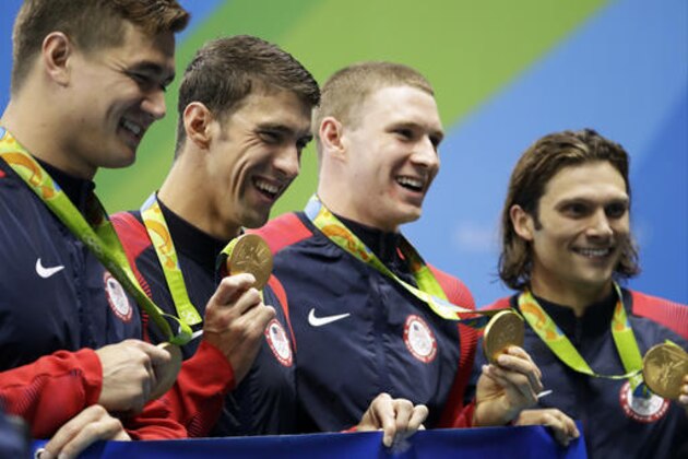From right to left, United States' Cody Miller, Ryan Murphy, Michael Phelps and Nathan Adrian display their medals during the medal ceremony for the men's 4 x 100-meter medley relay final during the swimming competitions at the 2016 Summer Olympics, Sunday, Aug. 14, 2016, in Rio de Janeiro, Brazil. ((AP Photo/Rebecca Blackwell)