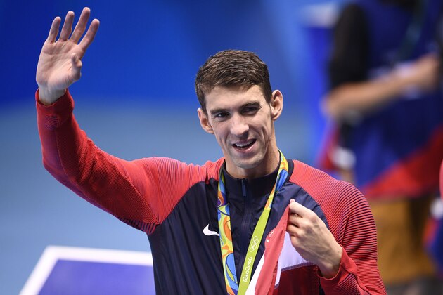USA's gold medallist Michael Phelps waves after the podium ceremony of the Men's swimming 4 x 100m Medley Relay Final at the Rio 2016 Olympic Games at the Olympic Aquatics Stadium in Rio de Janeiro on August 13, 2016.   / AFP / Martin BUREAU        (Photo credit should read MARTIN BUREAU/AFP/Getty Images)