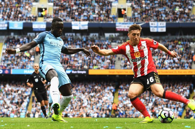 MANCHESTER, ENGLAND - AUGUST 13:  Bacary Sagna of Manchester City (L) attempts to black Lynden Gooch of Sunderland (R) shot during the Premier League match between Manchester City and Sunderland at Etihad Stadium on August 13, 2016 in Manchester, England.  (Photo by Stu Forster/Getty Images)