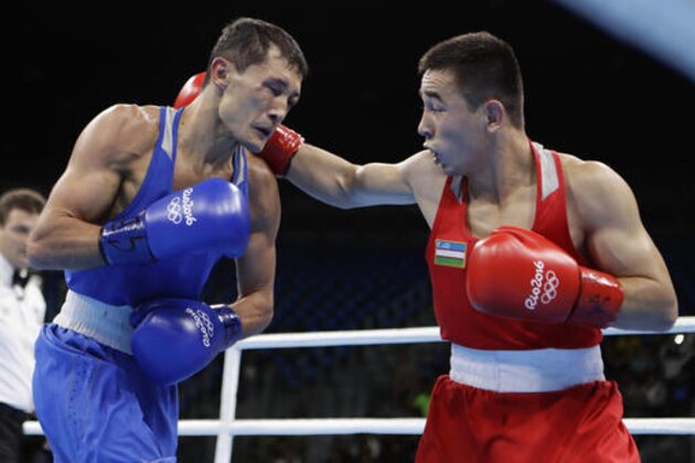 Uzbekistan's Hasanboy Dusmatov, right, fights Kazakhstan's Birzhan Zhakypov during a men's light flyweight 49-kg quarterfinals boxing match at the 2016 Summer Olympics in Rio de Janeiro, Brazil, Wednesday, Aug. 10, 2016. (AP Photo/Frank Franklin II)