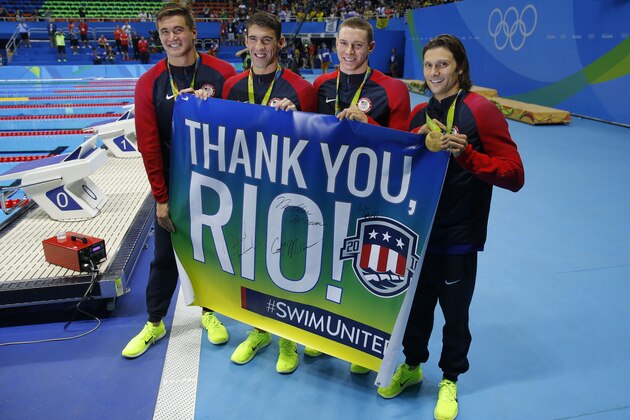 USA's gold medallist team Nathan Adrian (L), Michael Phelps, Ryan Murphy, Cody Miller (R), pose with a banner 'Thank You rio' during the podium ceremony of the Men's swimming 4 x 100m Medley Relay Final at the Rio 2016 Olympic Games at the Olympic Aquatics Stadium in Rio de Janeiro on August 13, 2016.   / AFP / Odd ANDERSEN        (Photo credit should read ODD ANDERSEN/AFP/Getty Images)