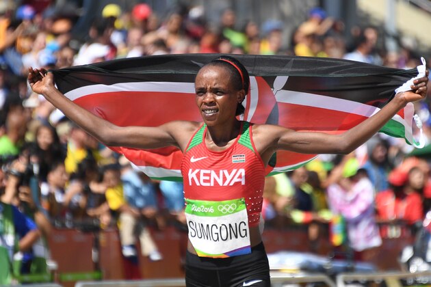 Kenya's Jemima Jelagat Sumgong celebrates her victory in the Women's Marathon during the athletics event at the Rio 2016 Olympic Games at Sambodromo in Rio de Janeiro on August 14, 2016.   / AFP / POOL / Johannes EISELE        (Photo credit should read JOHANNES EISELE/AFP/Getty Images)