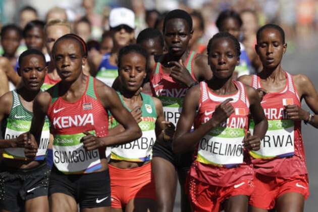 Athletes compete in the women's marathon during the Summer Olympics athletics event in Rio de Janeiro, Brazil, Sunday, Aug. 14, 2016. At left, front, is Jemima Jelagat Sumgong, of Kenya. Behind right of her is Mare Dibaba, of Ethiopia. Second from right is Rose Chelimo, of Bahrain. At far right is Eunice Jepkirui Kirwa, of Bahrain. (AP Photo/Robert F. Bukaty)