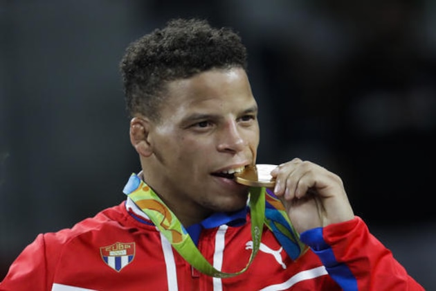 Gold medalist Cuba's Ismael Borrero Molina celebrates during the winners ceremony for the men's wrestling Greco-Roman 59-kg competition at the 2016 Summer Olympics in Rio de Janeiro, Brazil, Sunday, Aug. 14, 2016. (AP Photo/Markus Schreiber)
