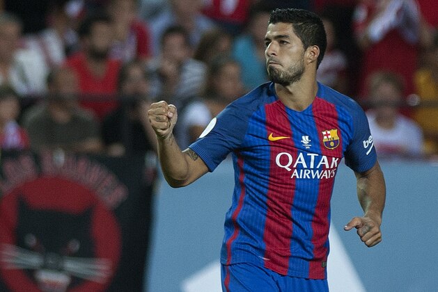 Barcelona's Uruguayan forward Luis alberto Suarez celebrates after scoring during the first leg of the Spanish Supercup football match between Sevilla FC and FC Barcelona at the Ramon Sanchez Pizjuan stadium in Sevilla on August 14, 2016. / AFP / JORGE GUERRERO        (Photo credit should read JORGE GUERRERO/AFP/Getty Images)