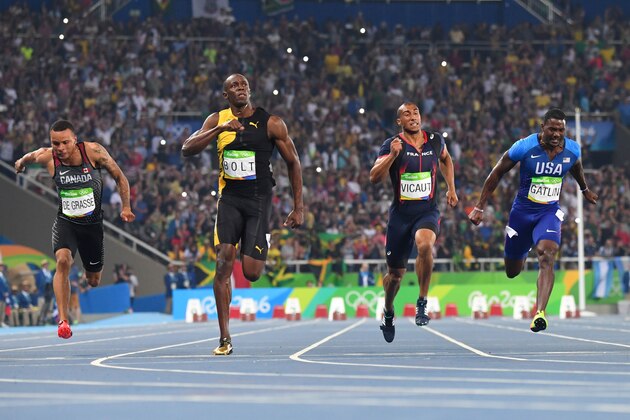 Jamaica's Usain Bolt (2ndL) reacts after he crossed the finish line head of USA's Justin Gatlin (R), Canada's Andre De Grasse (L) and France's Jimmy Vicaut to win the Men's 100m Final during the athletics event at the Rio 2016 Olympic Games at the Olympic Stadium in Rio de Janeiro on August 14, 2016.   / AFP / OLIVIER MORIN        (Photo credit should read OLIVIER MORIN/AFP/Getty Images)