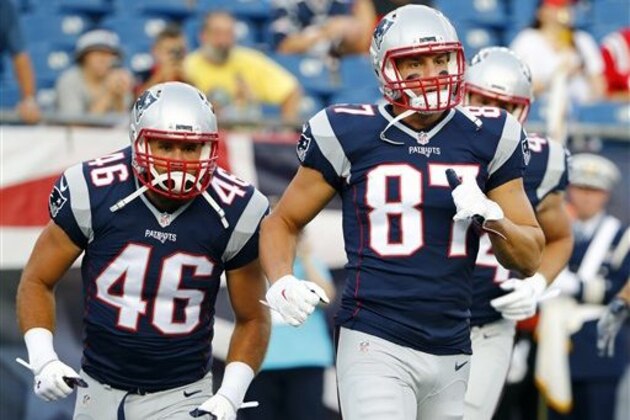 New England Patriots fullback James Develin (46) and tight end Rob Gronkowski (87) warm up before a preseason NFL football game against the New Orleans Saints Thursday, Aug. 11, 2016, in Foxborough, Mass. (AP Photo/Winslow Townson)