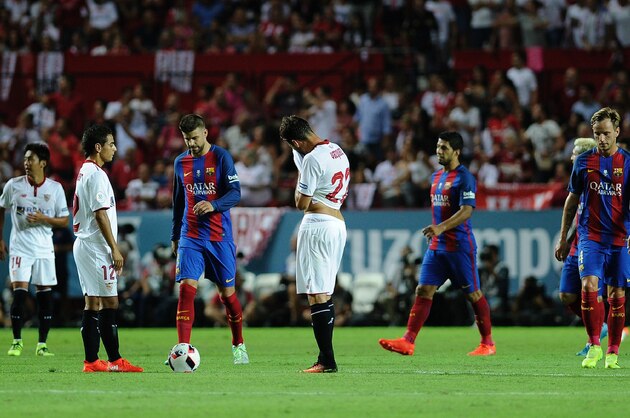 Sevilla's players react after Barcelona's forward Munir El Haddadi scored a goal during the first leg of the Spanish Supercup football match between Sevilla FC and FC Barcelona at the Ramon Sanchez Pizjuan stadium in Sevilla on August 14, 2016. / AFP / CRISTINA QUICLER        (Photo credit should read CRISTINA QUICLER/AFP/Getty Images)