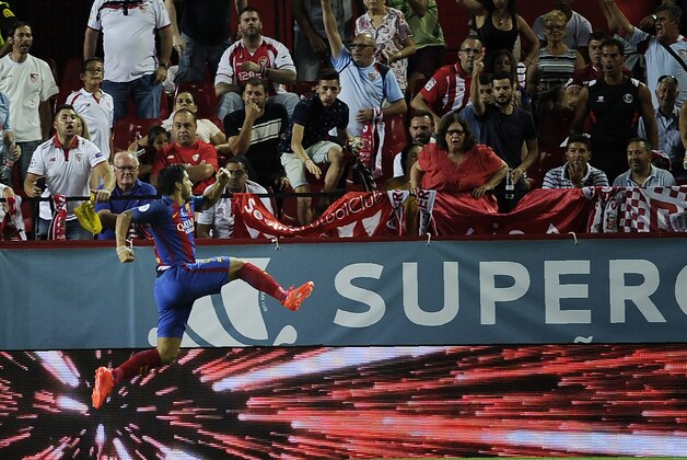Barcelona's Uruguayan forward Luis Alberto Suarez celebrates after scoring during the first leg of the Spanish Supercup football match between Sevilla FC and FC Barcelona at the Ramon Sanchez Pizjuan stadium in Sevilla on August 14, 2016. / AFP / CRISTINA QUICLER        (Photo credit should read CRISTINA QUICLER/AFP/Getty Images)