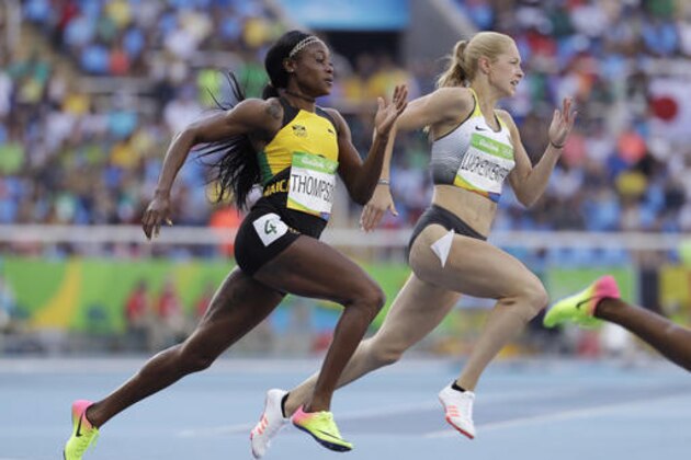 Jamaica's Elaine Thompson, left, and Germany's Gina Luckenkemper compete in a women's 200-meter heat during the athletics competitions of the 2016 Summer Olympics at the Olympic stadium in Rio de Janeiro, Brazil, Monday, Aug. 15, 2016. (AP Photo/Natacha Pisarenko)