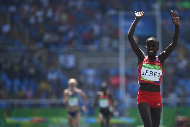Bahrain's Ruth Jebet celebrates after she won the Women's 3000m Steeplechase Final during the athletics event at the Rio 2016 Olympic Games at the Olympic Stadium in Rio de Janeiro on August 15, 2016.   / AFP / OLIVIER MORIN        (Photo credit should read OLIVIER MORIN/AFP/Getty Images)