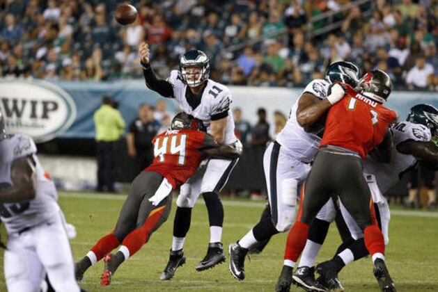 Philadelphia Eagles quarterback Carson Wentz (11) throws a pass as he is hit by Tampa Bay Buccaneers linebacker Micah Awe (44) during the second half of a preseason NFL football game Thursday, Aug. 11, 2016, in Philadelphia. (AP Photo/Chris Szagola)