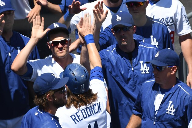 LOS ANGELES, CA - AUGUST 14: Josh Reddick #11 of the Los Angeles Dodgers is greeted in the dugout after scoring a run in the first inning of the game against the Pittsburgh Pirates at Dodger Stadium on August 14, 2016 in Los Angeles, California. (Photo by Jayne Kamin-Oncea/Getty Images)