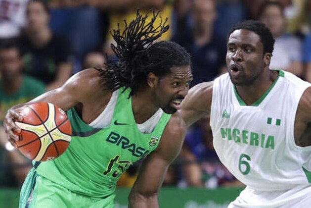 Brazil's Nene Hilario (13) drives around Nigeria's Ike Diogu (6) during a men's basketball game at the 2016 Summer Olympics in Rio de Janeiro, Brazil, Monday, Aug. 15, 2016. (AP Photo/Eric Gay)