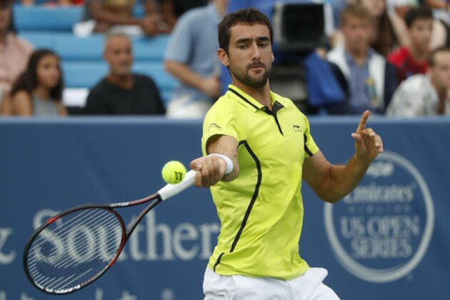 Marin Cilic, of Croatia, returns to Viktor Troicki, of Serbia, on the third day of the Western & Southern Open tennis tournament, Monday, Aug. 15, 2016, in Mason, Ohio. (AP Photo/John Minchillo)