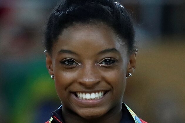 Bronze medallist US gymnast Simone Biles poses on the podium of the women's balance beam event final of the Artistic Gymnastics at the Olympic Arena during the Rio 2016 Olympic Games in Rio de Janeiro on August 15, 2016. / AFP / Thomas COEX        (Photo credit should read THOMAS COEX/AFP/Getty Images)