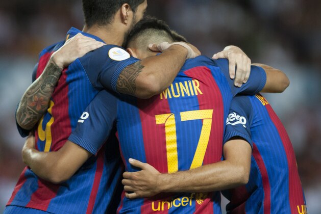 Barcelona's forward Munir El Hadidi (C) celebrates with his teammates after scoring during the first leg of the Spanish Supercup football match between Sevilla FC and FC Barcelona at the Ramon Sanchez Pizjuan stadium in Sevilla on August 14, 2016. / AFP / JORGE GUERRERO        (Photo credit should read JORGE GUERRERO/AFP/Getty Images)