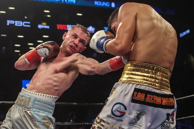 NEW YORK, NY - JULY 30:  Leo Santa Cruz of Mexico (gold trunks) fights Carl Frampton of Northern Ireland (blue trunks) during their  12 round WBA Super  featherweight championship  bout  at Barclays Center on July 30, 2016 in the Brooklyn borough in New York City. (Photo by Anthony Geathers/Getty Images)