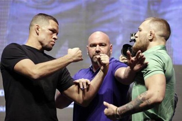 Dana White, center, stands between Nate Diaz, left, and Conor McGregor during a UFC 202 mixed martial arts news conference, Thursday, July 7, 2016, in Las Vegas. Diaz and McGregor are scheduled to fight at UFC 202 in Las Vegas. (AP Photo/John Locher)
