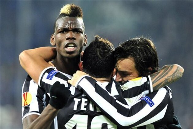 Juventus midfielder Paul Pogba, of France, celebrates after scoring with teammates Andrea Pirlo, right, and Carlos Tevez, center, during the Europa League, round of 16th, soccer match between Juventus and Trabzonspor at the Juventus stadium, in Turin, Italy, Thursday, Feb. 20, 2014. (AP Photo/Massimo Pinca)