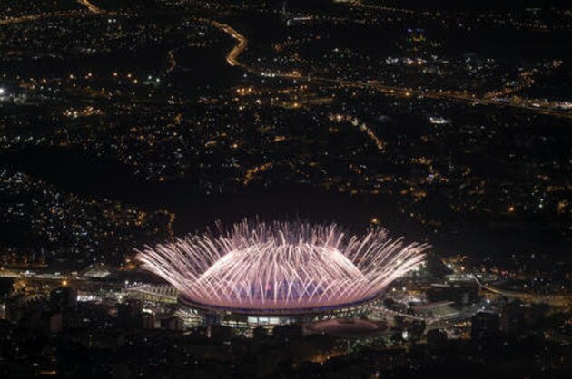 In this Aug. 5, 2016 photo, fireworks explode over Maracana Stadium during the opening ceremony at the 2016 Summer Olympics in Rio de Janeiro, Brazil. Hillary Clinton has the airwaves all to herself during the Rio Olympics. Her Democratic presidential campaign is spending more than $13.6 million on TV commercials during the three weeks of the Summer Games. Republican Donald Trump hasn’t put up a single general election ad yet. (AP Photo/Felipe Dana)