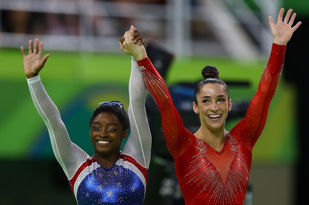 RIO DE JANEIRO, BRAZIL - AUGUST 11:  Simone Biles (L) of the United States waits for the score after competing on the floor with Alexandra Raisman (R) during the Women's Individual All Around Final on Day 6 of the 2016 Rio Olympics at Rio Olympic Arena on August 11, 2016 in Rio de Janeiro, Brazil.  (Photo by Amin Mohammad Jamali/Getty Images)