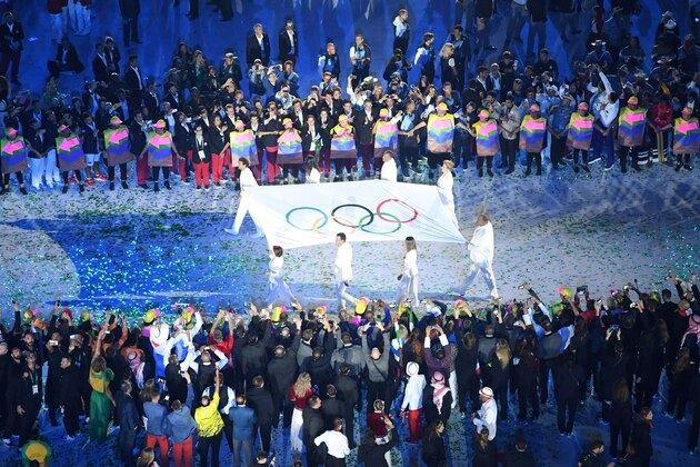 The Olympic flag is carried before being raised during the opening ceremony of the Rio 2016 Olympic Games at the Maracana stadium in Rio de Janeiro on August 5, 2016. / AFP / Antonin THUILLIER        (Photo credit should read ANTONIN THUILLIER/AFP/Getty Images)
